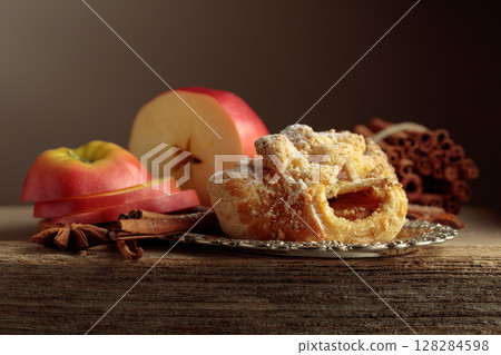 Viennese strudel with apple and cinnamon on old wooden table. 128284598