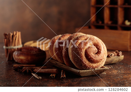 Swedish cinnamon rolls on a brown background. 128284602