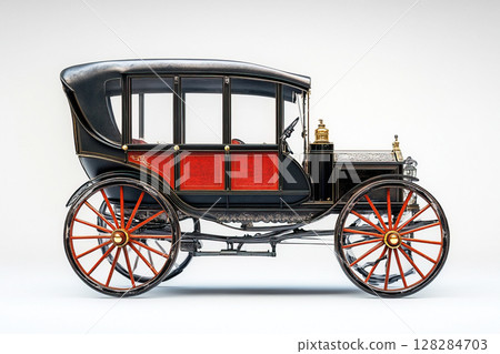 Antique carriage with red accents on a white background emphasizing its retro design details 128284703