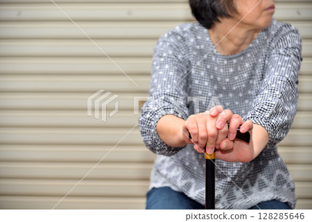 Seniors walking with a cane and taking a break Image 128285646