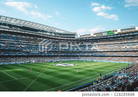 Exciting European football match at a historic stadium under a clear sky 128285686