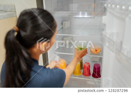 Efficiently Organizing Fresh Juices Within a Modern Refrigerator for Easy Access 128287296