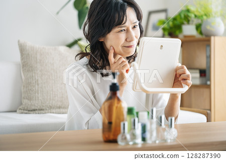 A middle-aged woman in her 50s suffering from skin problems A middle-aged woman in her 50s suffering from skin problems 128287390