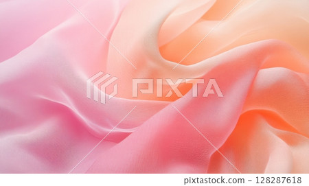 Soft pastel fabric draped elegantly showcasing gradient hues from pink to orange in a delicate arrangement 128287618