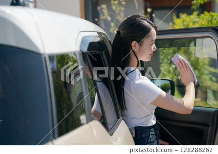 Woman cleaning the car Woman cleaning the car 128288262