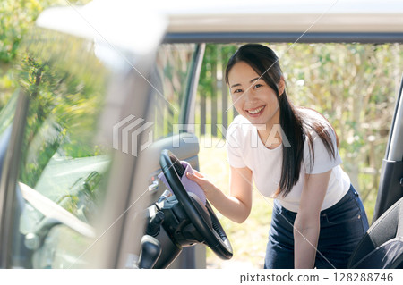 Woman cleaning the car Woman cleaning the car 128288746
