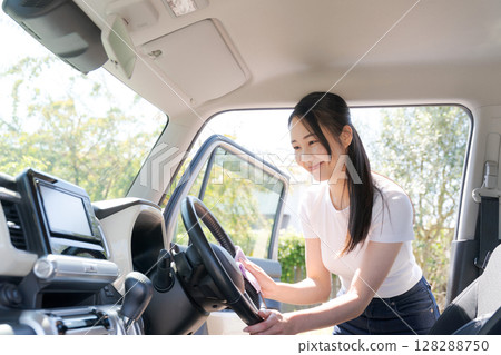 Woman cleaning the car 128288750