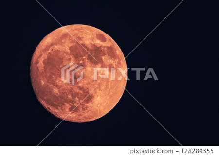 Red full moon over dark sky at night Red full moon over dark sky at night 128289355