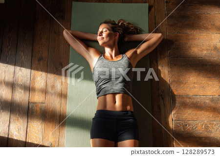 Young woman doing yoga stretches in the living room at home Young woman doing yoga stretches in the living room at home 128289573