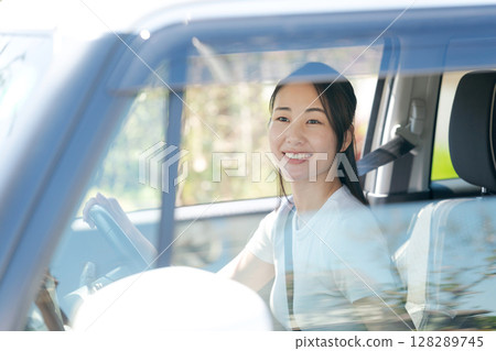 A woman driving a car A woman driving a car 128289745