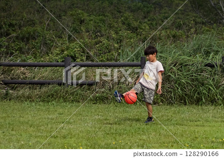 <Material> Boys playing soccer energetically in the park 128290166