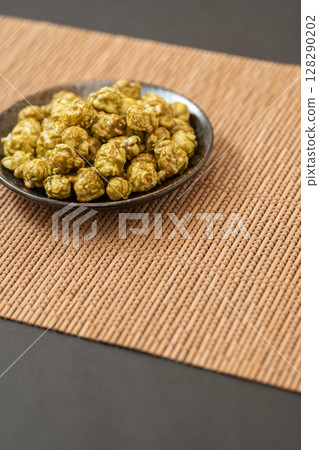 Matcha popcorn on a Japanese style background Matcha popcorn on a Japanese style background 128290202