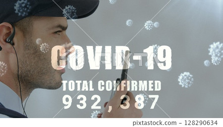 Image of a word covid-19 with total confirmed number rising and cells floating over caucasian man 128290634
