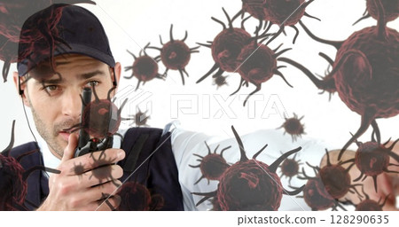 Image of cells floating over caucasian man using walkie talkie 128290635