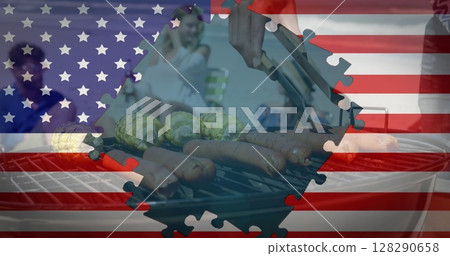 Image of american flag waving with jigsaw puzzles revealing friends having bbq on beach by seaside 128290658