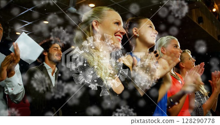 Image of macro coronavirus Covid 19 cells over smiling audience applauding at a theatre Image of macro coronavirus Covid 19 cells over smiling audience applauding at a theatre 128290778