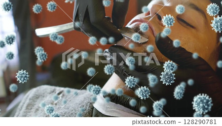 Wearing gloves, barber shaving man's beard with virus particles illustrated around Wearing gloves, barber shaving man's beard with virus particles illustrated around 128290781