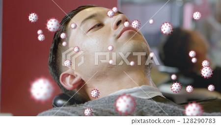 Lying back, man surrounded by digital coronavirus graphics illustrating health concept 128290783