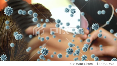 Image of cells spreading over hands of male hairdresser combing the hair of a male customer 128290798