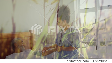Image of grass on a windy field over nurse checking on her senior male patient at the hospital 128290848