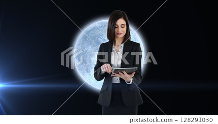 Image of woman using tablet over planet earth with glowing spot of light Image of woman using tablet over planet earth with glowing spot of light 128291030