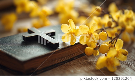 Beautiful yellow flowers surround a cross and holy bible in a serene worship setting 128291204