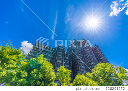 Yokohama cityscape in Japan - Summer sky... View of scaffolding and protective nets for repairs and inspections of apartment buildings - July 10th 128291252