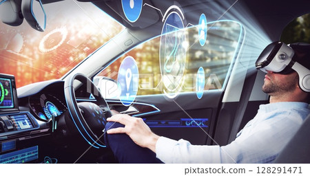 Image of icons over businessman wearing vr headset in self driving car 128291471