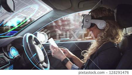 Image of digital interface over woman wearing vr headset in self driving car 128291476