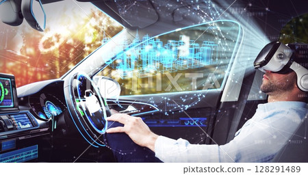Image of 3d cityscape drawing over businessman wearing vr headset in self driving car 128291489