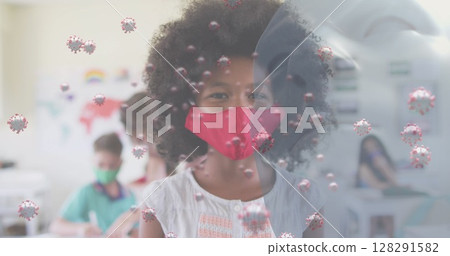 Image of floating covid 19 cells and schoolgirl in class wearing face mask 128291582