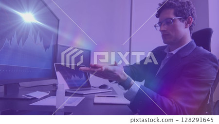 Digital composite image of spots of light against caucasian man using hand sanitizer at office Digital composite image of spots of light against caucasian man using hand sanitizer at office 128291645