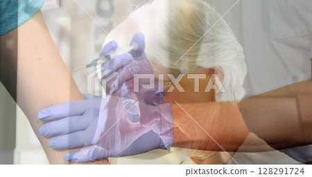 Image of worried senior woman with hands of doctor giving vaccination to patient 128291724