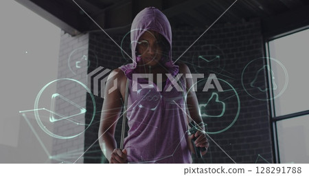Image of technological icons over woman exercising in an abandoned building 128291788
