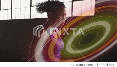 Image of colourful circles over woman jogging in an abandoned building 128291805