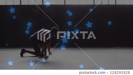 Multiple blue stars floating against african american woman in start position ready to run Multiple blue stars floating against african american woman in start position ready to run 128291828