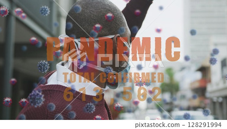 Pandemic text with increasing cases against african american man wearing face mask hailing a taxi 128291994