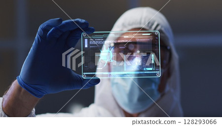 Image of male scientist holding digital screen with covid 19 cell 128293066