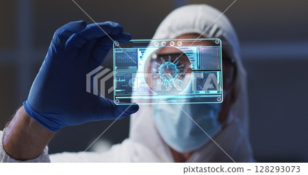 Image of male scientist holding digital screen with covid 19 cell 128293073