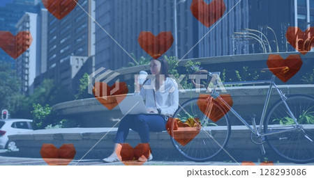 Image of heart love icons over woman using laptop in city Image of heart love icons over woman using laptop in city 128293086