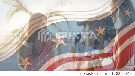 Multiple stars on blue stripes against two caucasian women taking on the beach 128293142