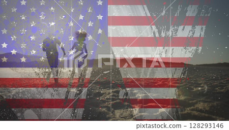 American flag with glitch effect against couple holding hands running together on the beach 128293146