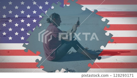 Image of american flag jigsaw puzzles revealing man using smartphone sitting on beach Image of american flag jigsaw puzzles revealing man using smartphone sitting on beach 128293171
