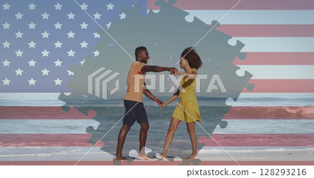 Image of american flag jigsaw puzzle revealing confetti and couple dancing on beach 128293216