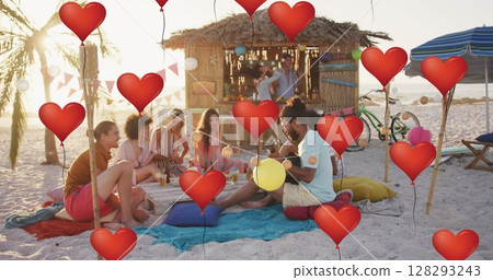 Image of red heart love balloons digital icons over friends having party on beach Image of red heart love balloons digital icons over friends having party on beach 128293243