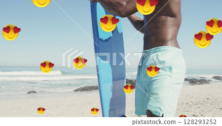 Multiple heart eyes emojis floating against african american man with surfboard on the beach Multiple heart eyes emojis floating against african american man with surfboard on the beach 128293252