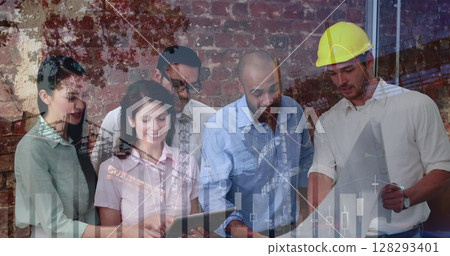 Collaborating on architectural project, diverse team reviewing blueprints with focus 128293401