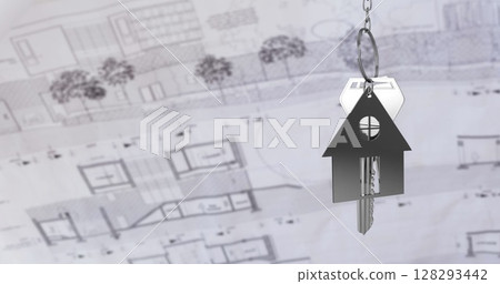 Keychain in house shape hanging over blueprints, symbolizing new home ownership 128293442