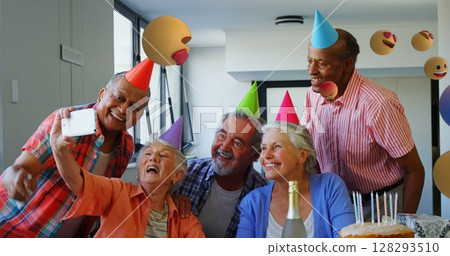 Elderly friends wearing party hats taking selfie during birthday celebration at home Elderly friends wearing party hats taking selfie during birthday celebration at home 128293510