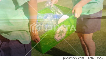 Collecting plastic bottles, children placing them in green recycling bin outdoors Collecting plastic bottles, children placing them in green recycling bin outdoors 128293552